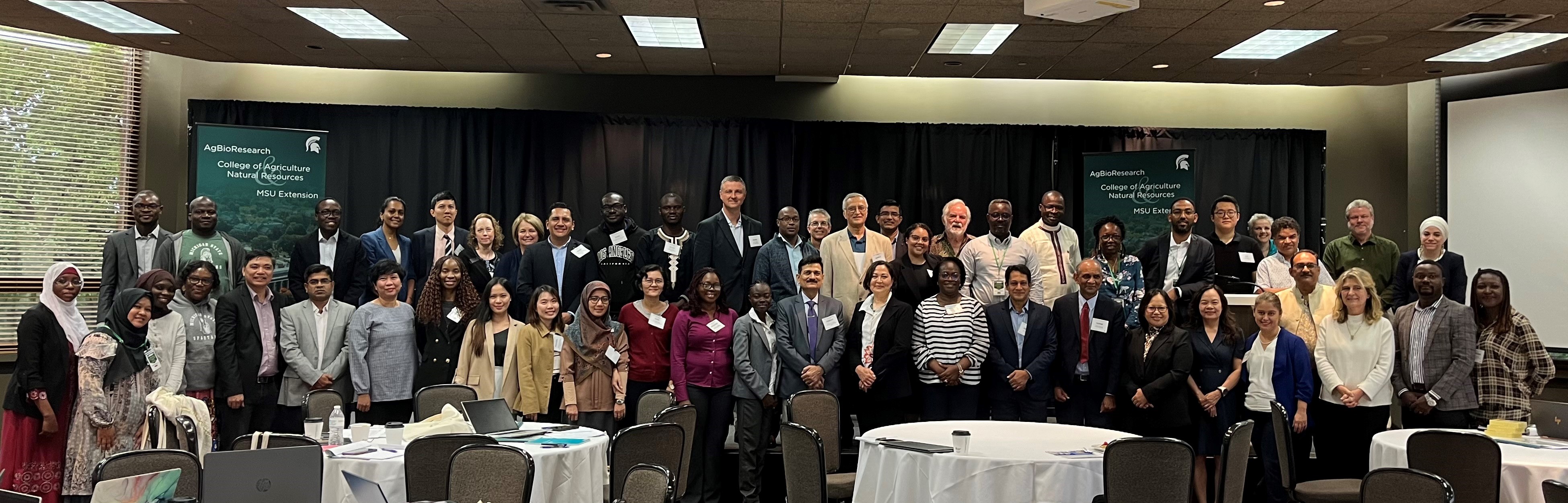 Attendees pose in two rows for a group photo